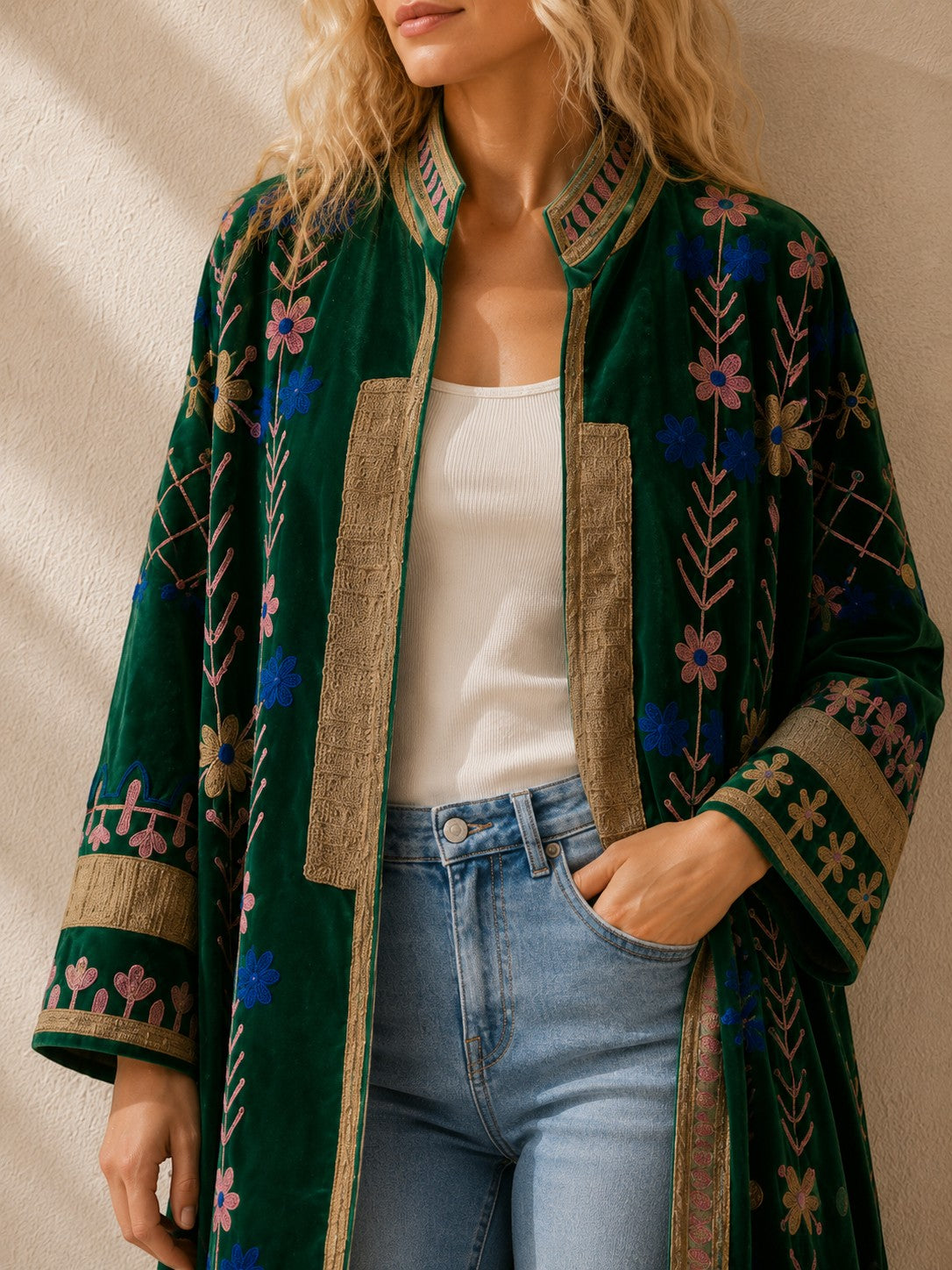 The House of Saffron long green velvet suzani jacket, made in india, featuring intricate floral suzani embroidery and gold trim details.