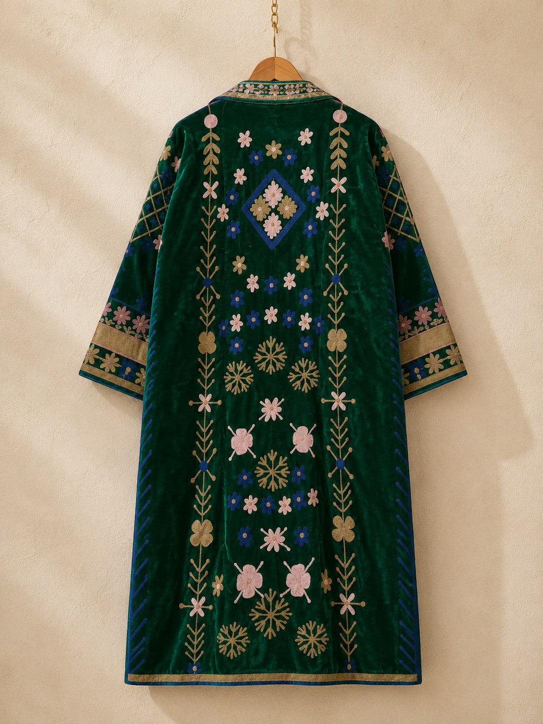 The House of Saffron long green velvet suzani jacket featuring intricate floral embroidery and a relaxed silhouette.