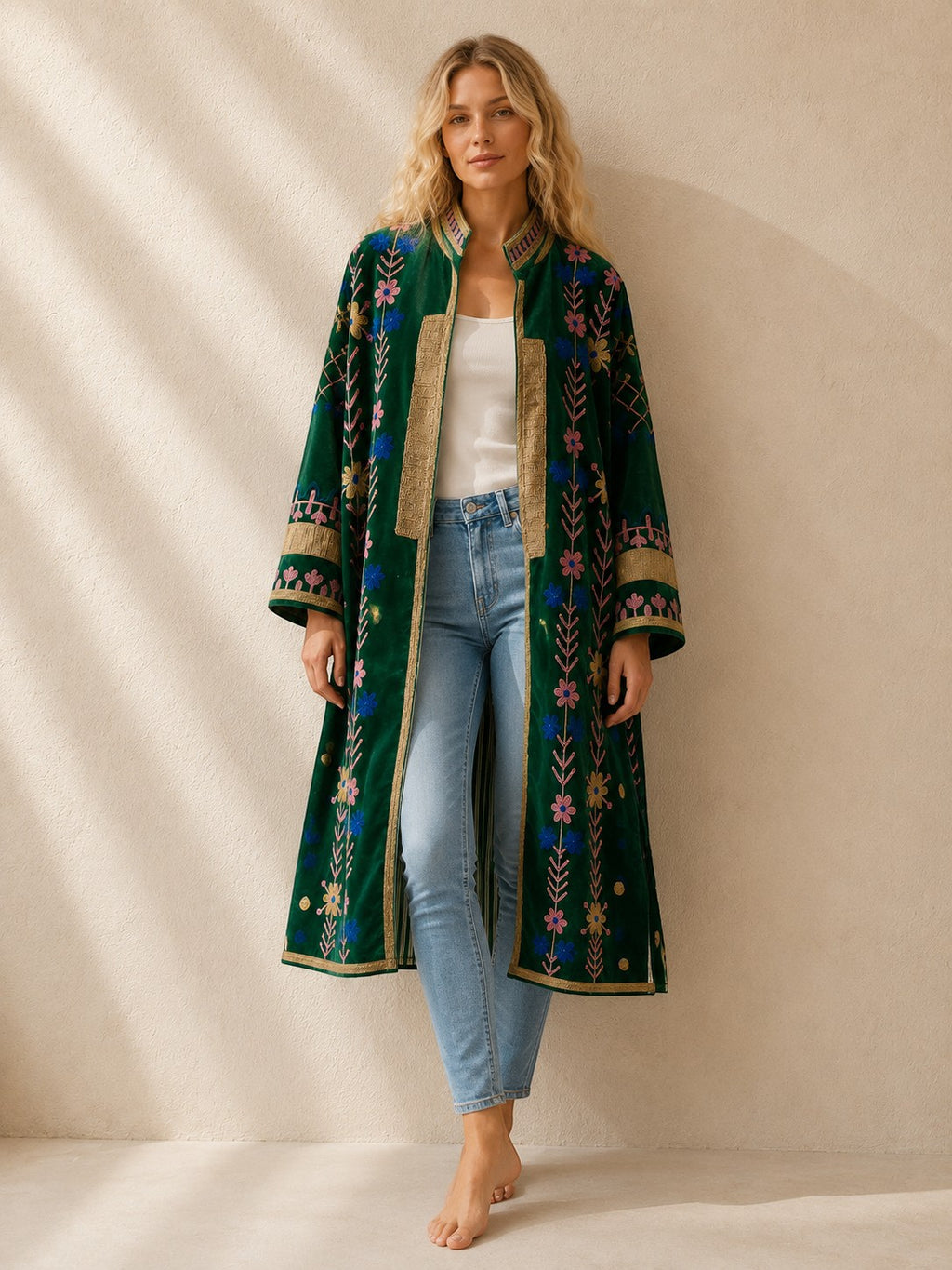 The House of Saffron long green velvet suzani jacket with intricate floral embroidery and heart-stitched border details.
