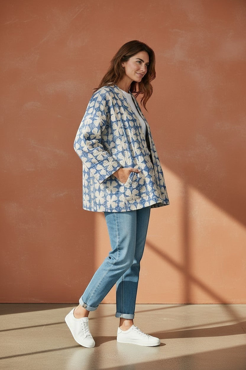 The House of Saffron reversible blue and white quilted cotton Kantha jacket with patch pockets worn by a model.