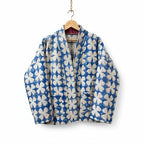 The House of Saffron Rajasthan Mist reversible cotton Kantha jacket with blue and white floral hand-stitched quilting.
