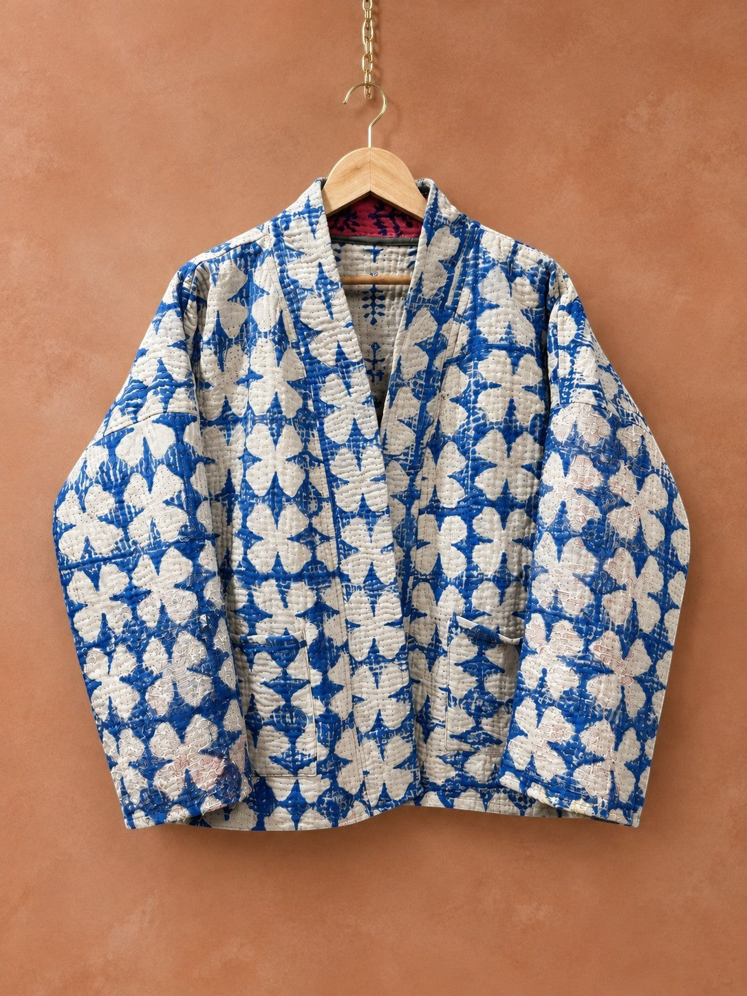 The House of Saffron reversible cotton Kantha jacket in blue and white floral print with hand-stitched quilting.