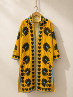 The House of Saffron long saffron velvet jacket with black floral suzani embroidery and a hand-stitched heart border.