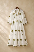 The House of Saffron white midi dress with olive green embroidered palm tree motifs, V-neckline, and patterned trim.